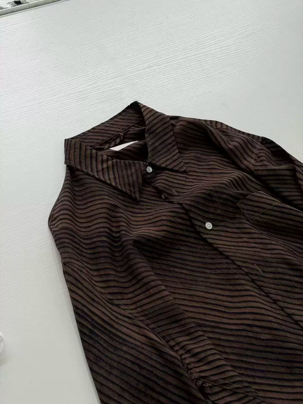 Umber wave-stripe fluid shirt — collar and placket detail
