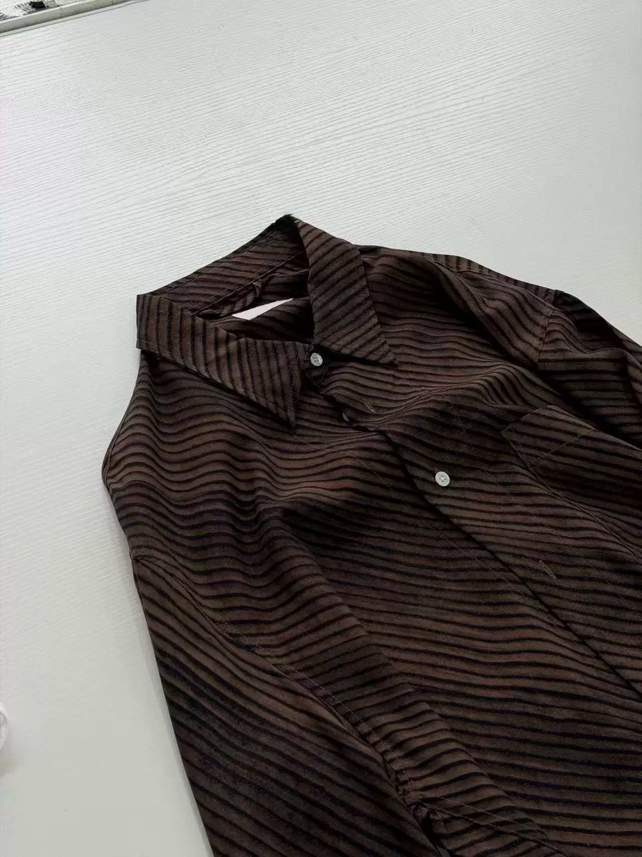 Umber wave-stripe fluid shirt — collar and placket detail