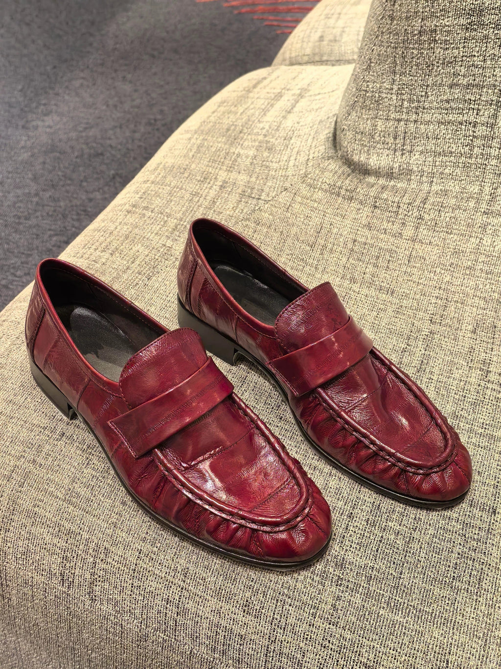 Bordeaux ruched eel leather loafers — pair, three-quarter view