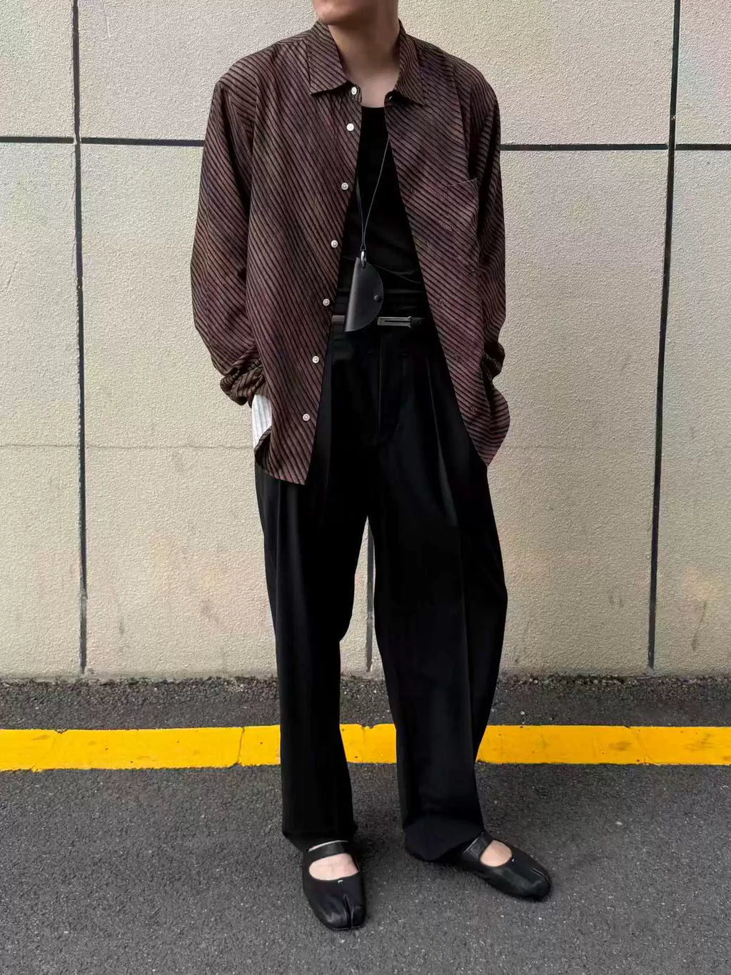 Umber wave-stripe fluid shirt — worn open over black, full look