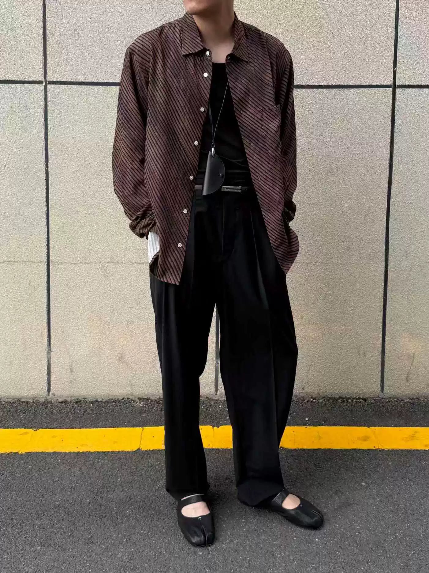 Umber wave-stripe fluid shirt — worn open over black, full look
